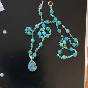 36” long turquoise colored stones with a cute hanging removable embellishment